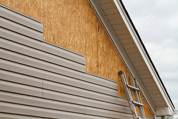 Professional Siding Replacement technician working in Slickville, PA